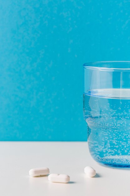 Szklanka wody z pigułkami