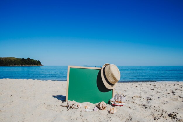 Tablica i słoma kapelusz na plaży