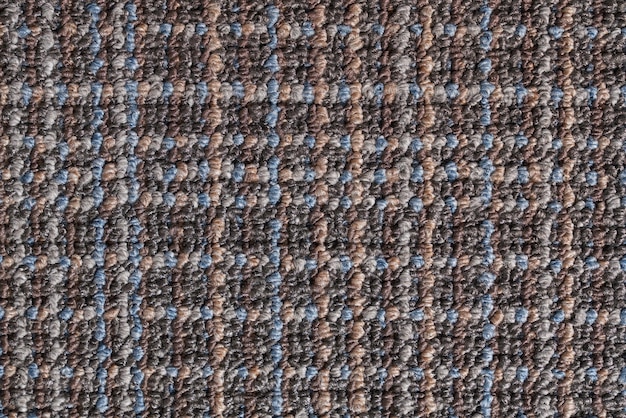 Bezpłatne zdjęcie teksturowana powierzchnia tła szarego dywanu ozdobiona wielobarwnym wzorem skrzyżowanych linii