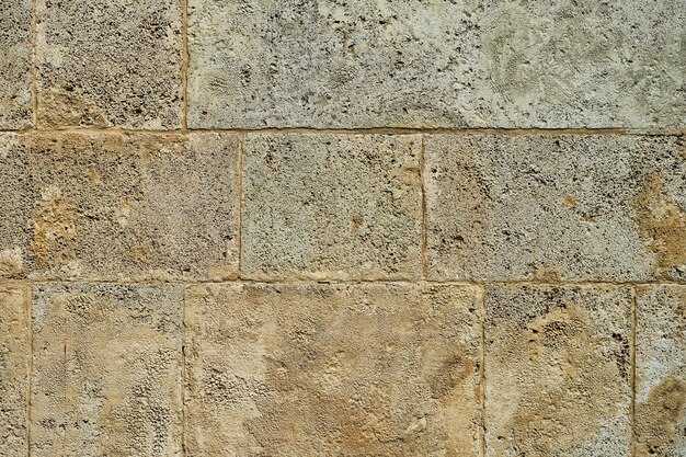 Tło starej kamiennej ściany dekoracji wnętrz domu z piaskowca lub pomysłu na projekt