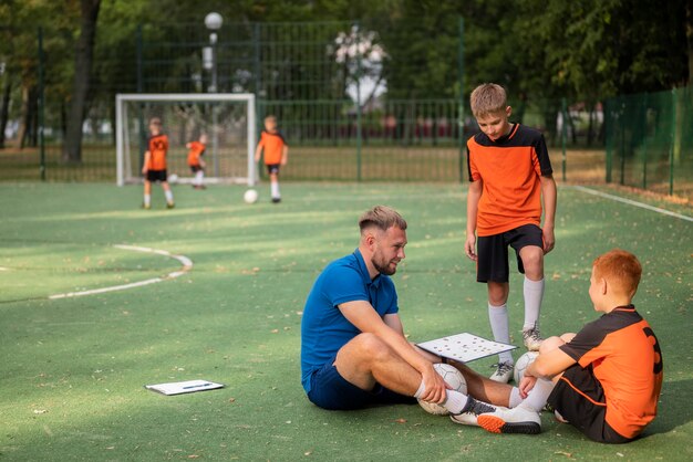 Trener piłki nożnej uczący swoich podopiecznych