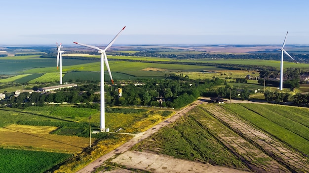 Bezpłatne zdjęcie trzy turbiny wiatrowe zlokalizowane na polu