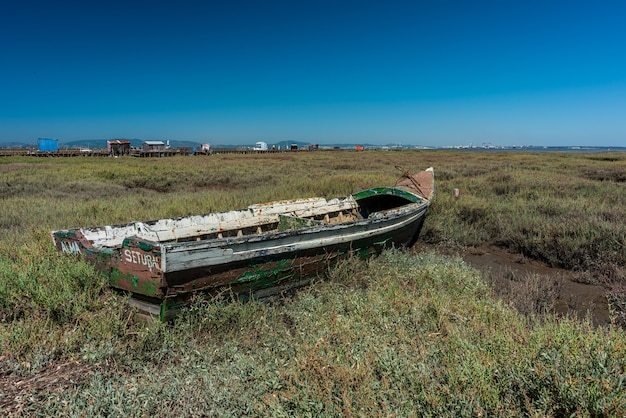 Ujęcie starej łodzi na środku łąki w Cais Palafítico da Carrasqueira, Portugalia