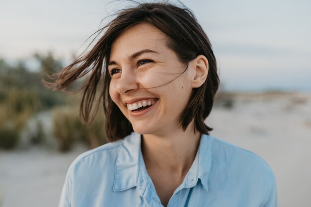 Uśmiechnięty portret szczery roześmiany kobieta na plaży