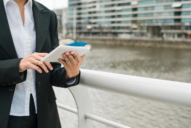 W połowie sekcja młoda kobieta stoi blisko schronienia używać telefon komórkowego