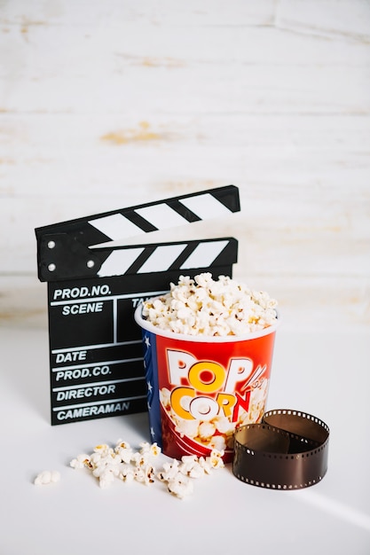 Bezpłatne zdjęcie wiadro popcorn między clapperboard i filmu