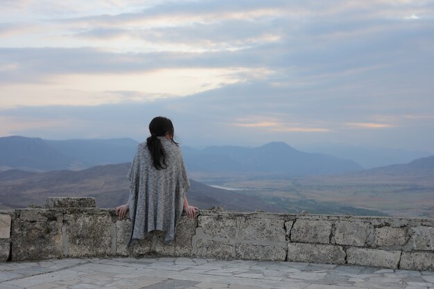 Widok młodej kobiety podziwiającej piękno gór w Karabachu z tyłu