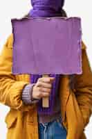 Bezpłatne zdjęcie widok osoby trzymającej pusty fioletowy plakat na świętowanie dnia kobiet