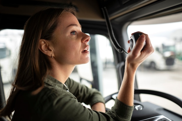 Bezpłatne zdjęcie widok z boku profesjonalny kierowca kobieta w ciężarówce