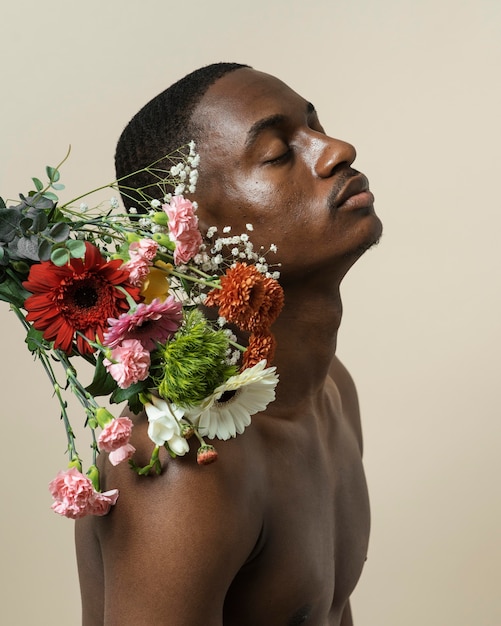 Bezpłatne zdjęcie widok z boku przystojny mężczyzna z bukietem kwiatów