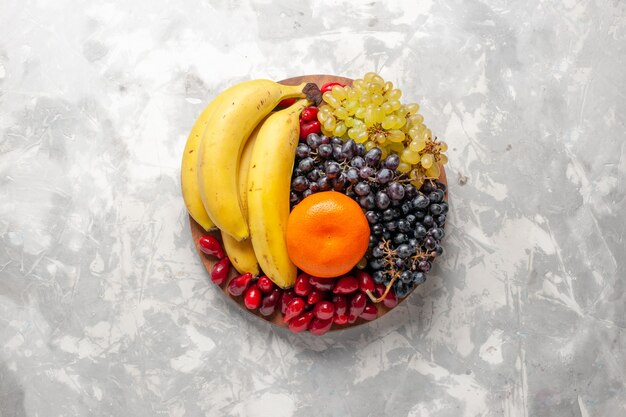 Widok z góry kompozycja owocowa świeże banany derenie i winogrona na białej powierzchni owoce jagoda świeżość witamina