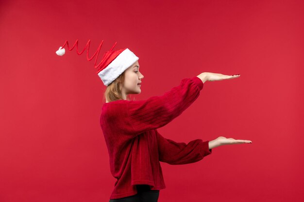 Widok z przodu młoda kobieta w czerwonej czapce pokazująca rozmiar, czerwona kobieta wakacje