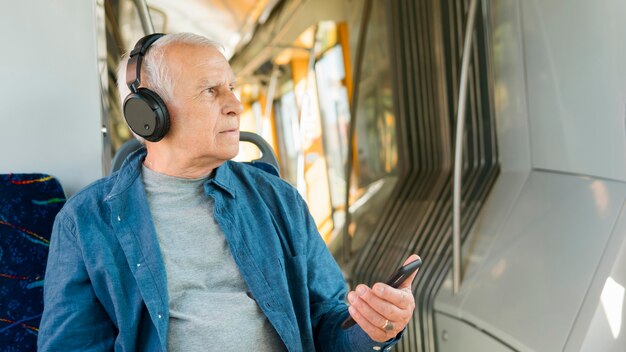 Widok z przodu starego człowieka w transporcie publicznym