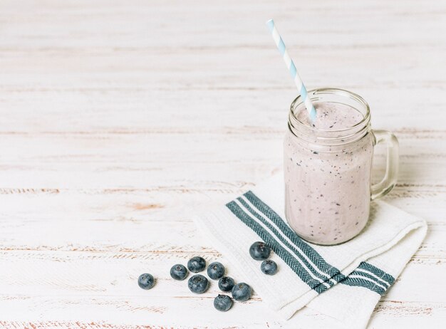 Wysoki kąt smoothie jagodami na tkaniny z miejsca na kopię