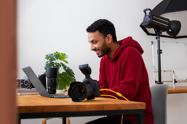 Bezpłatne zdjęcie wyspecjalizowany fotograf o średnim ujęciu pracujący w studio