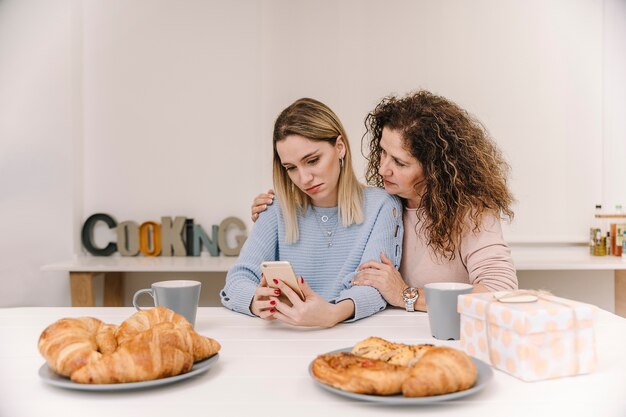 Wzburzona matka i córka przeglądania smartphone