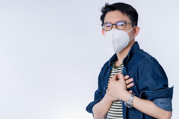 Zamknij się młody azjatycki biznesmen płci męskiej noszący maskę przeciw zanieczyszczeniom z gestem ekspresowym chory choroba zły stan zdrowia od pogody z pm25 środowisko miasto problem z powietrzem