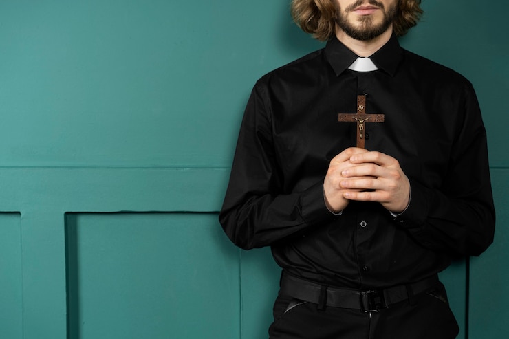 Bezpłatny plik Zdjęcie zamknij się pastor trzymający krzyż