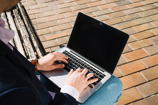 Zamyka up biznesmen używa laptop outdoors