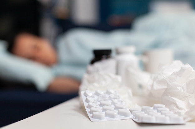 Zbliżenie na butelki i tabletki dla chorej kobiety z wirusem
