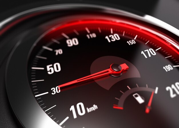 Zbliżenie na prędkościomierz samochodowy z igłą skierowaną 30 km h, efekt rozmycia, obraz koncepcyjny dla koncepcji bezpiecznej jazdy