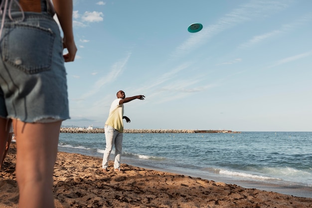 Bezpłatne zdjęcie zbliżenie przyjaciół bawiących się na plaży