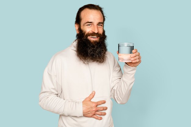 Zdrowy brodaty mężczyzna trzymający szklankę wody