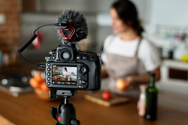 Żeński vlogger nagrywa kucharstwo odnosić sie transmisję w domu