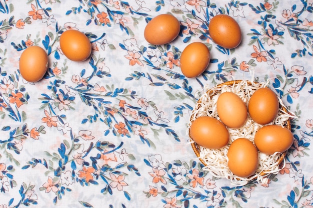 Bezpłatne zdjęcie zestaw kurzych jaj w misce na ukwieconym materiale