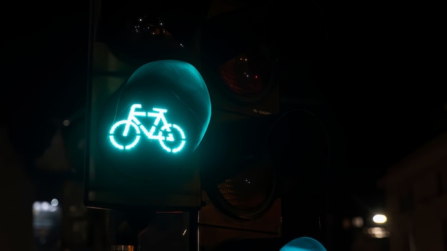 Zielona sygnalizacja świetlna z logo roweru w nocy w Bukareszcie, Rumunia