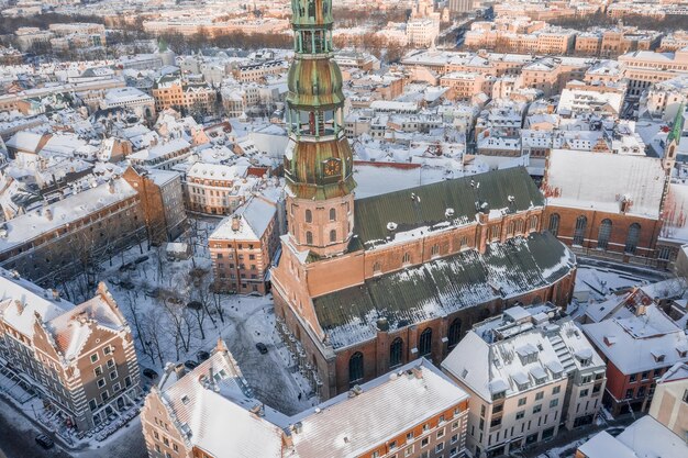 Zimowy widok z lotu ptaka na kościół św. piotra w rydze, łotwa. zimowy dzień nad starym miastem w rydze, łotwa.