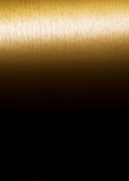Bezpłatne zdjęcie złocistego tekstury tła gradientowy pionowo czerń