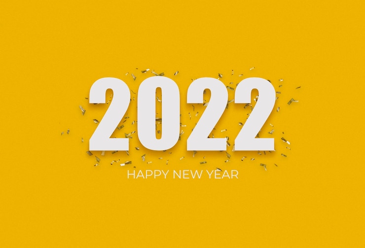 Photo Gratis 2022 white sign over yellow confetti on a yellow background