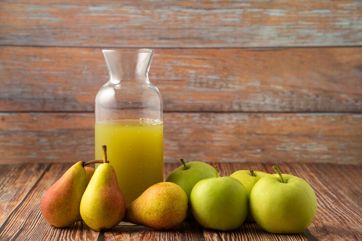 Photo Gratis a glass jar of juice with green apples and pears around