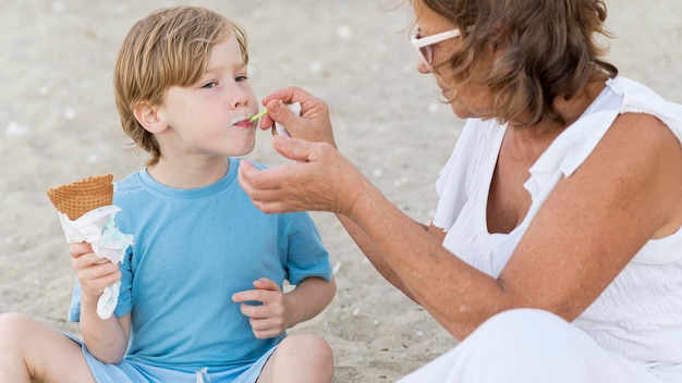 Foto gratuita abuela alimentando a niño con helado