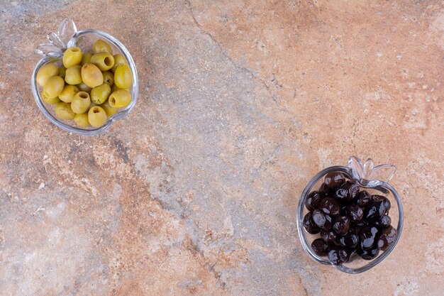 Aceitunas verdes y negras en vasos de vidrio