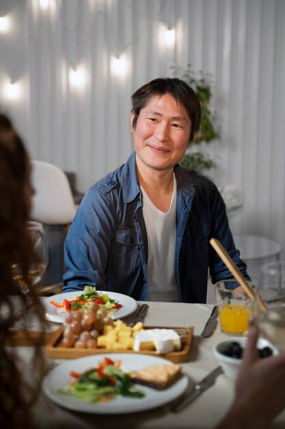 Acercamiento a un adulto joven en una cena con amigos