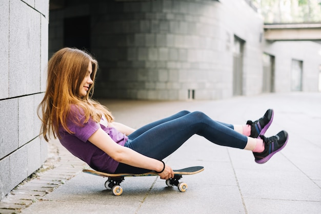 Foto gratuita adolescente en patineta tratando de moverse