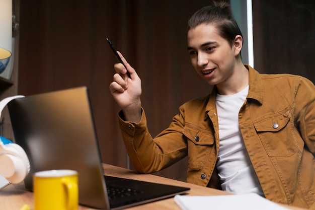 Adolescente que tiene una videollamada en casa en una computadora portátil