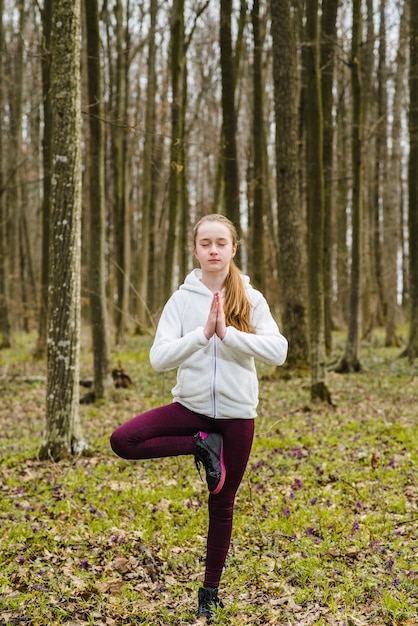 Foto gratuita adolescente relajado en pose de árbol