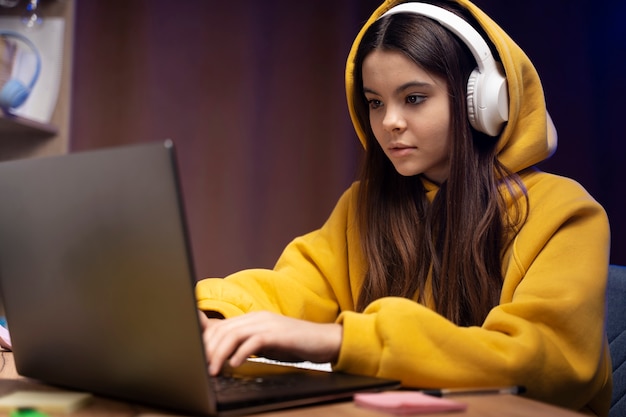 Adolescente usando laptop en casa