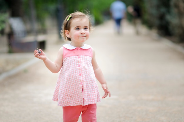 Adorable niña jugando en un parque urbano