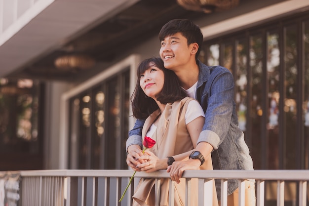 Adorable pareja con una rosa en las manos