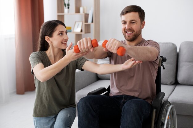 Adulto joven ayudando a un amigo discapacitado