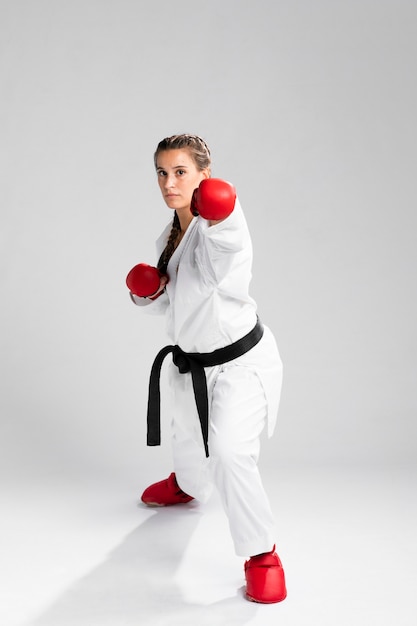 Foto gratuita adulto joven con cinturón negro luchador karate de entrenamiento