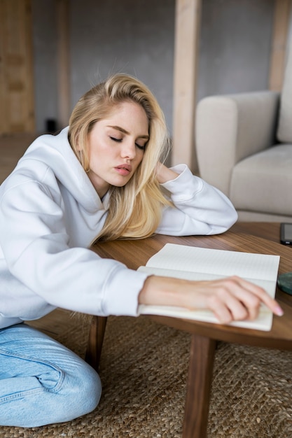 Adulto joven durmiendo mientras hace la tarea