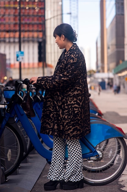 Foto gratuita adulto joven usando bicicleta para viajar en la ciudad