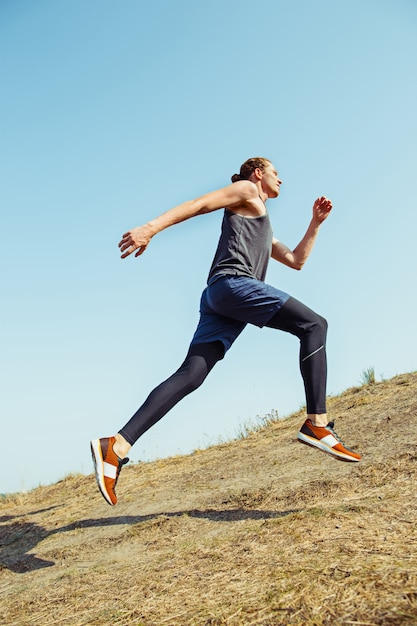 Ajuste musculoso atleta masculino sendero de entrenamiento para correr maratón