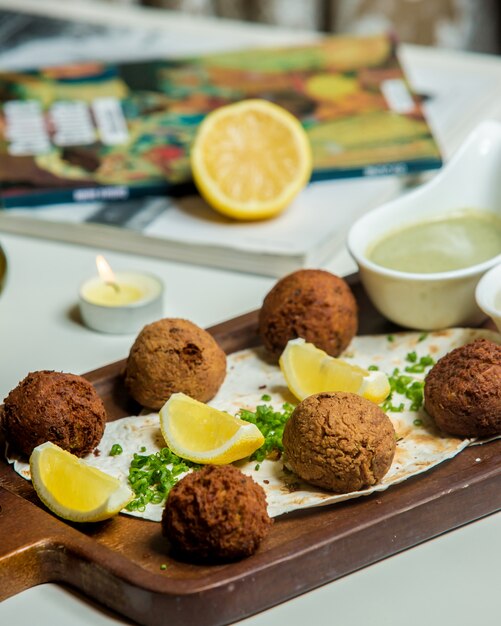 Albóndigas servidas con limón y salsa