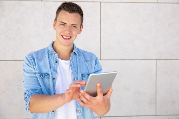 Alegre joven usando tableta